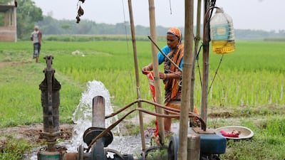 A woman washes clothes at an irrigation pump in Manikganj, Bangladesh. Annual water spending in developing countries totals about 0.5 per cent of their GDP. Reuters