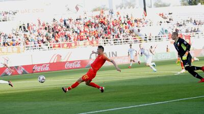 Yu Dabao slots the ball into an empty net for China to take the lead, EPA