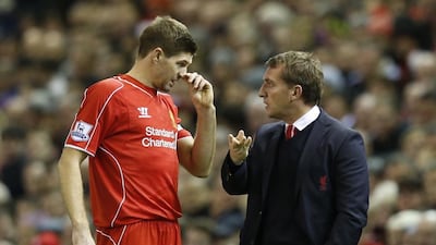 Liverpool manager Brendan Rodgers, right, talks to Steven Gerrard during a break in their English Premier League match against Arsenal at Anfield in Liverpool, northern England December 21, 2014. REUTERS/Phil Noble