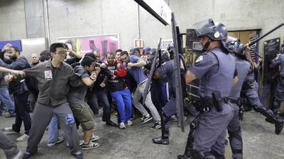 Subway train operators, along with some activists, clash with police at the Ana Rosa metro station on the second day of their metro strike in Sao Paulo, Brazil, on June 6, 2014. Nelson Antoine / AP Photo