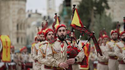 Palestinian scout pipe band members parade through Manger Square at the Church of the Nativity in Bethlehem, in the occupied West Bank, on Christmas Eve. AP Photo