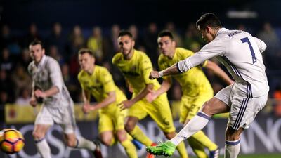 Real Madrid’s Portuguese forward Cristiano Ronaldo, right, scores against Villarreal. Biel Alino / AFP