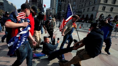 Pro-Trump demonstrators remove a counter-protester during a rally in Boston, Massachusetts on October 18. Reuters