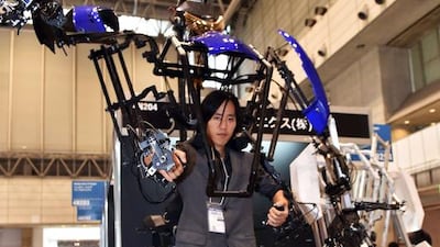 A man wears the lightweight robot suit Skeletonics, which expands its users’ motions two times. Yoshikazu Tsuno / AFP