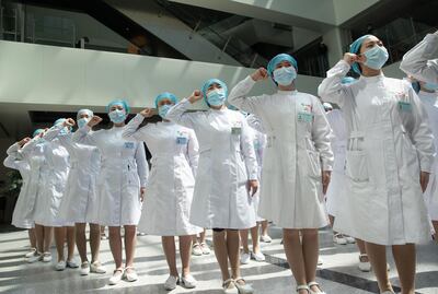 Nurses recite an oath during a ceremony marking International Nurses Day in Wuhan, China. AFP