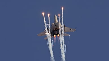 An F-15 fighter fires air defence flares. The aircraft has played a key role in the US strikes on Iran. AFP