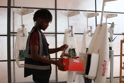 An employee of the Silicon Valley company Zipline prepares a drone that will fly life-saving blood supplies to a remote clinic in Rwanda. Getty.