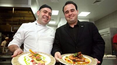 Oscar Selfa, left, and Fernando Fernandez in the Amerigos restaurant kitchen on Yas Island with two Mexican dishes: ceviche de atun and gambas saltedas al ajillo.