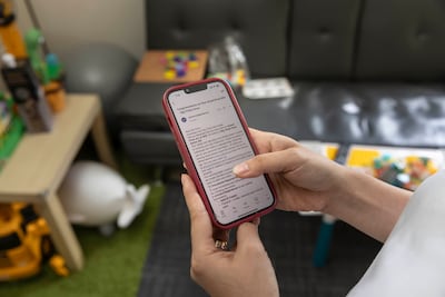 Big Ticket winner Anna Gayongan reads the email congratulating her on her win. Antonie Robertson / The National