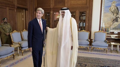 John Kerry, the US Secretary of State, left, talks with Qatar's Emir Sheikh Tamim bin Hamad Al Thani before a meeting at the Diwan Palace in Doha. Brendan Smialowski / AFP Photo