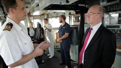 Lt Cdr Richard Hutchings, captain of HMS Pembroke, speaks to Alistair Burt, the UK's minister for the Middle East and South Asia.