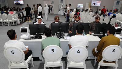 Officials offer assistance during the visa amnesty at the General Directorate of Residency and Foreigners Affairs Dubai in Al Awir. Pawan Singh / The National