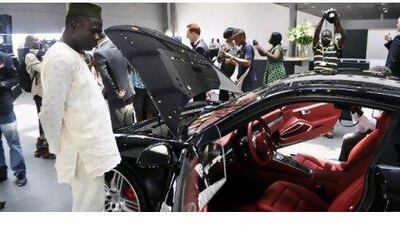 A Nigerian man looks at a Porsche in a Lagos showroom. Nigeria has more than 2 million millionaires who are increasingly travelling abroad to spend on luxury goods. Monica Mark / Reuters