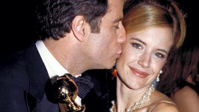 John Travolta, who won a Golden Globe for Best Actor in a Motion Picture Comedy or Musical for his role in 'Get Shorty,' kisses wife Kelly Preston at the MGM / United Artists Studio party in 1996. AFP