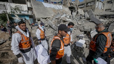 Palestinian civil defence workers recover bodies from the grounds of Salah Al Din mosque, Gaza city. EPA
