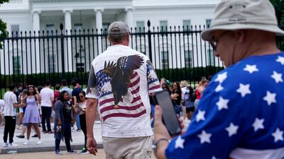 People gather on a section of Pennsylvania Avenue that was reopened to the public in front of the White House in Washington, DC.
