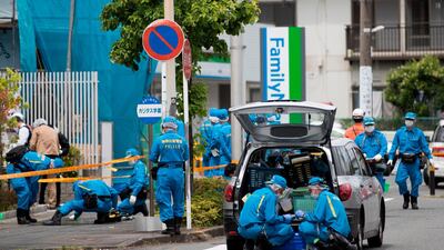 Police forensic experts work at the scene where a man stabbed 19 people, including children, in Kawasaki, Japan, on Tuesday AFP