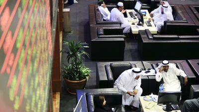 Traders at the Dubai Financial Market. The banking and financial sector will gain a full working day in line with global standards due to the recent move. Sarah Dea / The National