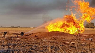 Syrian firefighters putting out a burning pipeline between the areas of Adra and Al Dhamir in the Damascus area. AFP