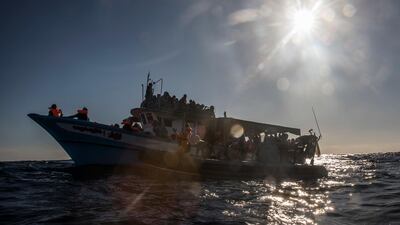 Workers from the Spanish NGO Proactiva Open Arms rescue more than 300 refugees and illegal migrants, mostly from Bangladesh and Eritrea, from an overcrowded wooden boat that set sail from Libya on January 27, 2018. Days later, on February 2, about 90 mostly Pakistani migrants were feared drowned after their boat capsized while trying to reach Europe from Libya. Santi Palacios / AP Photo