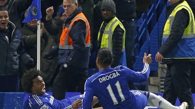 Chelsea’s Willian celebrates with Didier Drogba after scoring the winning goal late in a 1-0 victory over Everton on Wednesday. Ian Kington / AFP