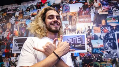 Arthur P, a photographer, in front of his photo collage