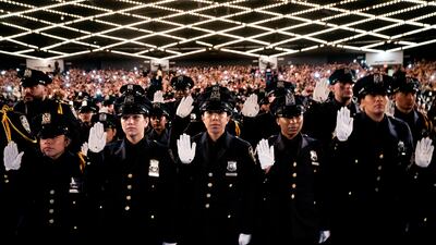 New York City Police Academy graduates raise their right hands as they take their oath during their graduation ceremony at Madison Square Garden, Friday, July 1, 2022, in New York. (AP Photo / John Minchillo)
