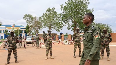 Nigerien soldiers stand guard as supporters of Niger's National Council for the Safeguard of the Homeland gather for a demonstration in Niamey. AFP