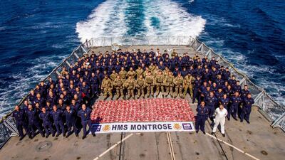 The crew of HMS Montrose stand with 275kg heroin seized from a suspect dhow. (Photo: AET Josh Edwards RN)