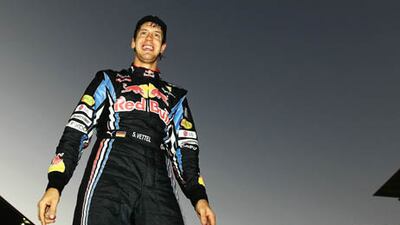 Sebastian Vettel of Germany and Red Bull Racing celebrates in the pitlane after winning the Japanese Formula One Grand Prix at Suzuka Circuit.