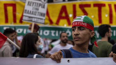 A pro-Palestinian protester holds a banner during a demonstration outside the Israeli embassy in Athens, Greece. Reuters