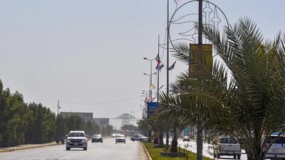 Municipality workers fix the flag of Vatican City on light poles in Iraq's holy city Najaf, ahead of the visit of Pope Francis. AFP