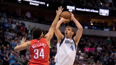 Dallas Mavericks forward Dirk Nowitzki makes a basket over New Orleans Pelicans guard Kenrich Williams. Reuters
