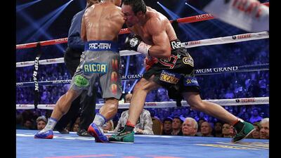 Juan Manuel Marquez, right, knocks out Manny Pacquiao, left, in the sixth round of their WBO world welterweight fight. Julie Jacobson / AP Photo