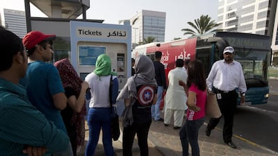 Commuters try to top up Hafilat cards at the Madinat Zayed stop, but the machine was not accepting notes. Christopher Pike / The National