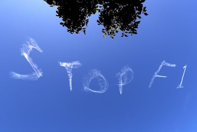 The words 'Stop F1' are seen in the Sydney sky on Wednesday ahead of the Australian Grand Prix. There have been calls for the race to be scrapped or barred to fans due to concerns about the coronavirus. AFP
