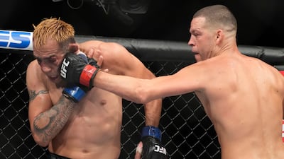 Nate Diaz hits Tony Ferguson during their welterweight bout at UFC 279. AP