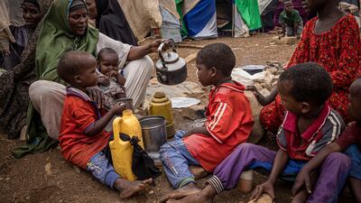A woman pours tea in a displacement camp in Baidoa, Somalia. Getty Images