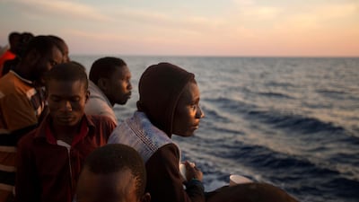 Sub-Saharan migrants stand on the deck of the Golfo Azzurro rescue vessel after being rescued by members of Proactive Open Arms, as they arrive at the port of Pozzallo, south of Sicily, Italy. Emilio Morenatti/AP Photo