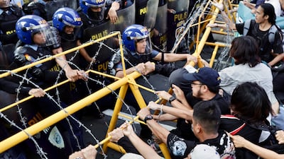 Protesters scuffle with anti-riot police during a demonstration to express their dissatisfaction with President Ferdinand Marcos Jr's third year in office, in Manila. EPA