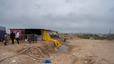Mr Ifranji, centre, talks to clients at the site of his horse riding school