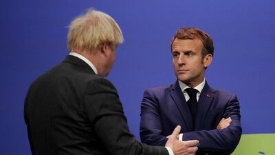 Britain's Prime Minister Boris Johnson and French President Emmanuel Macron at the Cop26 summit earlier this month. AFP