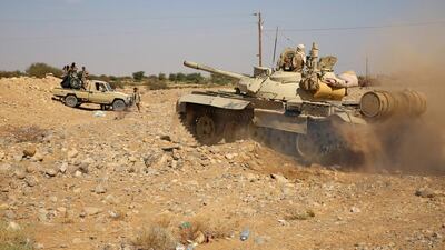Armed Yemeni tribesmen from the Popular Resistance Committees, supporting forces loyal to Yemen's government, hold a position in the area of Sirwah, west of Marib city, on December 18, 2015. AFP Photo
