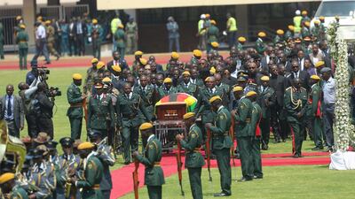 The casket of former president Robert Mugabe, covered by the national flag and followed by family and dignitaries, arrives for a state funeral at the National Sports Stadium in the capital Harare, Zimbabwe. African heads of state and envoys are gathering to attend a state funeral for Mugabe, whose burial has been delayed for at least a month until a special mausoleum can be built for his remains. AP Photo