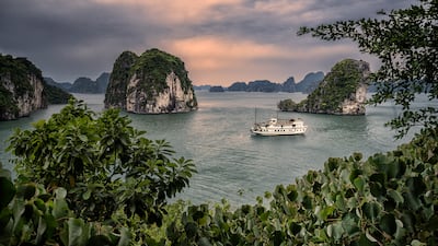 A ship cruises Bai Tu Long Bay in Vietnam. Getty Images