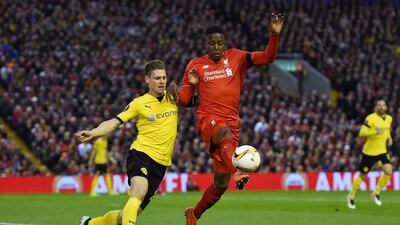 Divock Origi of Liverpool challenges for the ball with Lukasz Piszczek of Borussia Dortmund. Shaun Botterill / Getty Images