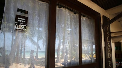 A closed sign hangs on the window of a beachfront shop as the government implements the temporary closure of the country's most famous beach resort island of Boracay. Aaron Favila / AP Photo