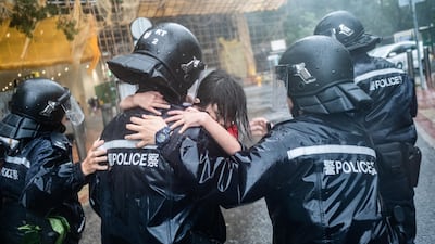 Police officers carry a girl out of a collapsed school in Hong Kong. Getty Images