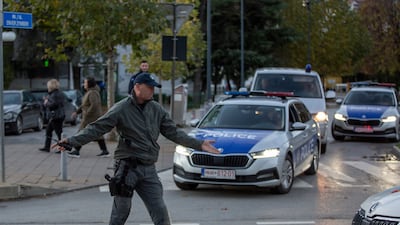 A Kosovo police officer directs the traffic around the stadium. AP