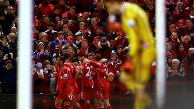 Adam Lallana of Liverpool celebrates with teammates after scoring his team's third goal in their 4-1 Premier League win over Swansea City on Monday. Clive Brunskill / Getty Images